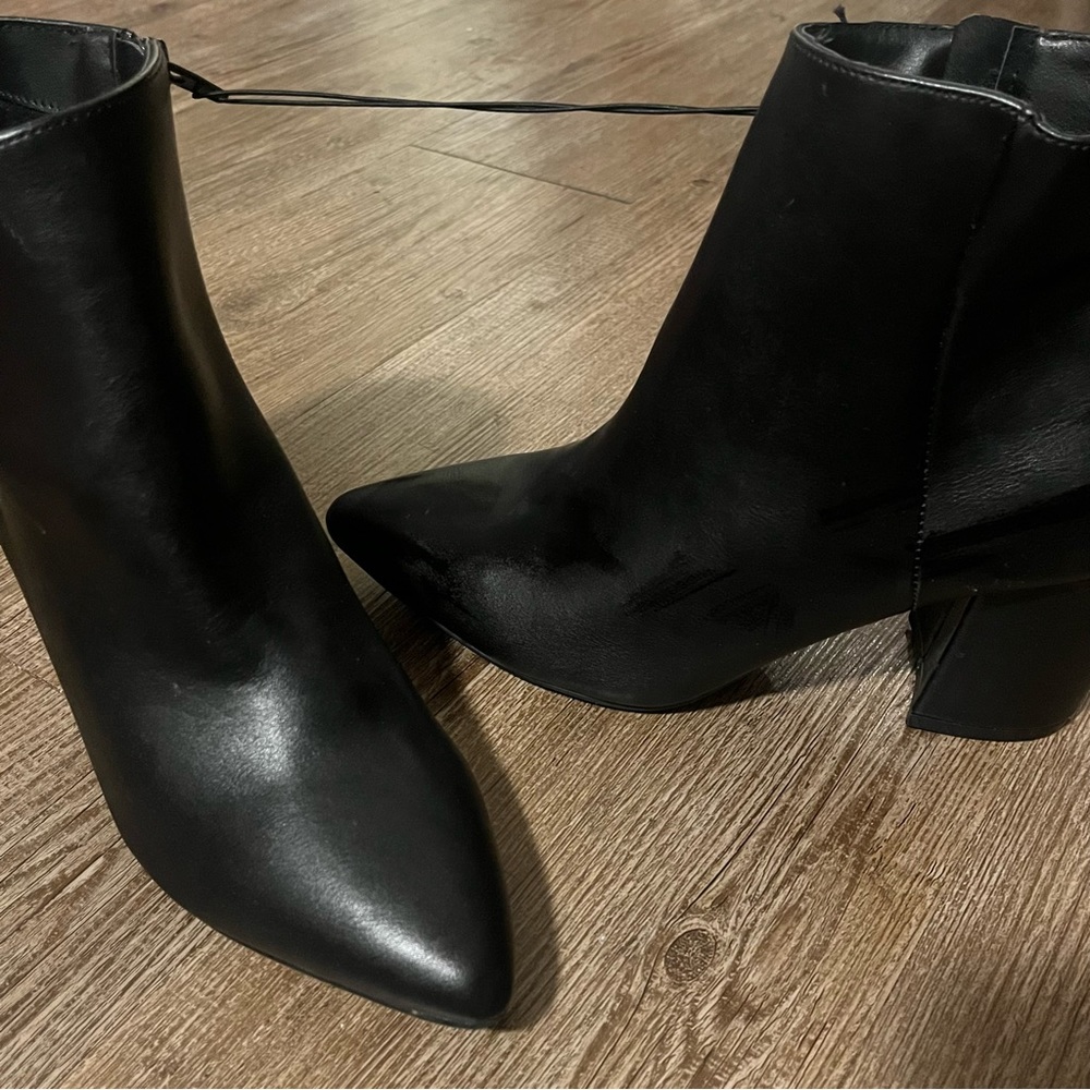 Black leather heeled boot.